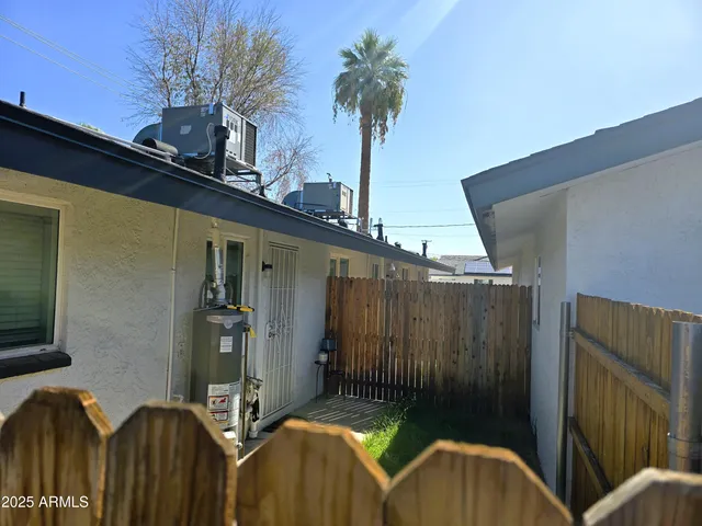 a view of backyard with outdoor seating and plants