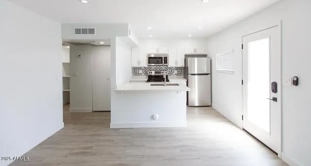 a kitchen with stainless steel appliances a refrigerator and a stove