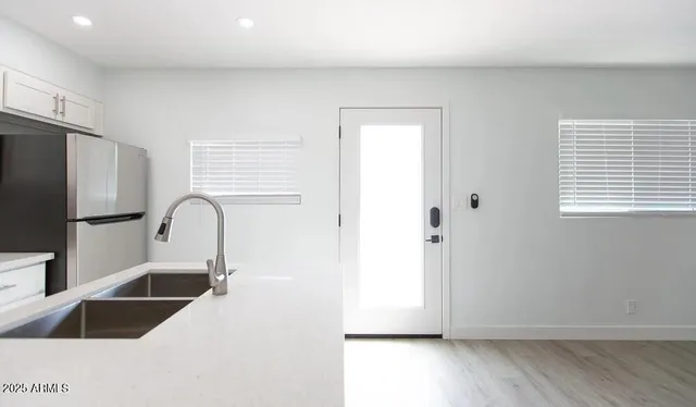 a kitchen with stainless steel appliances a refrigerator and a sink
