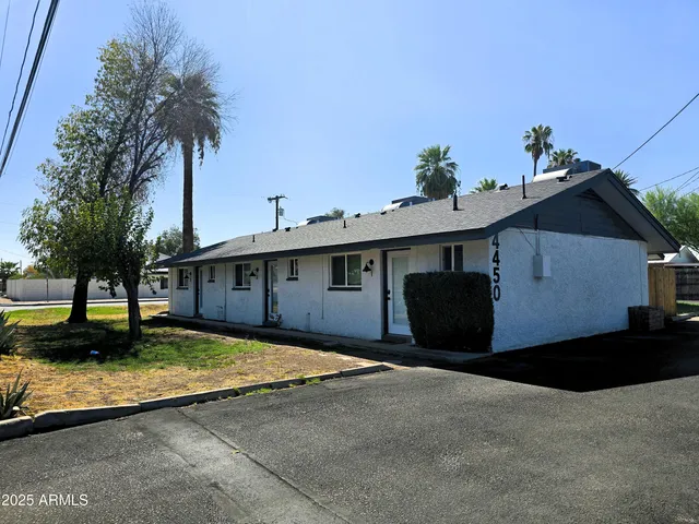 a house that has a tree in front of it