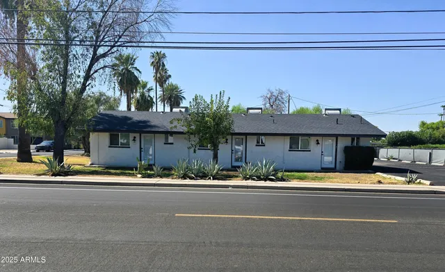 a front view of a house with a garden