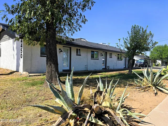 a view of a house with backyard outdoor seating area