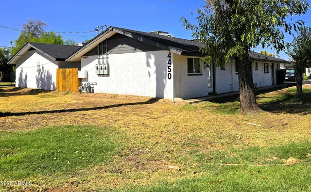 a view of a room with wooden floor and a ceiling fan