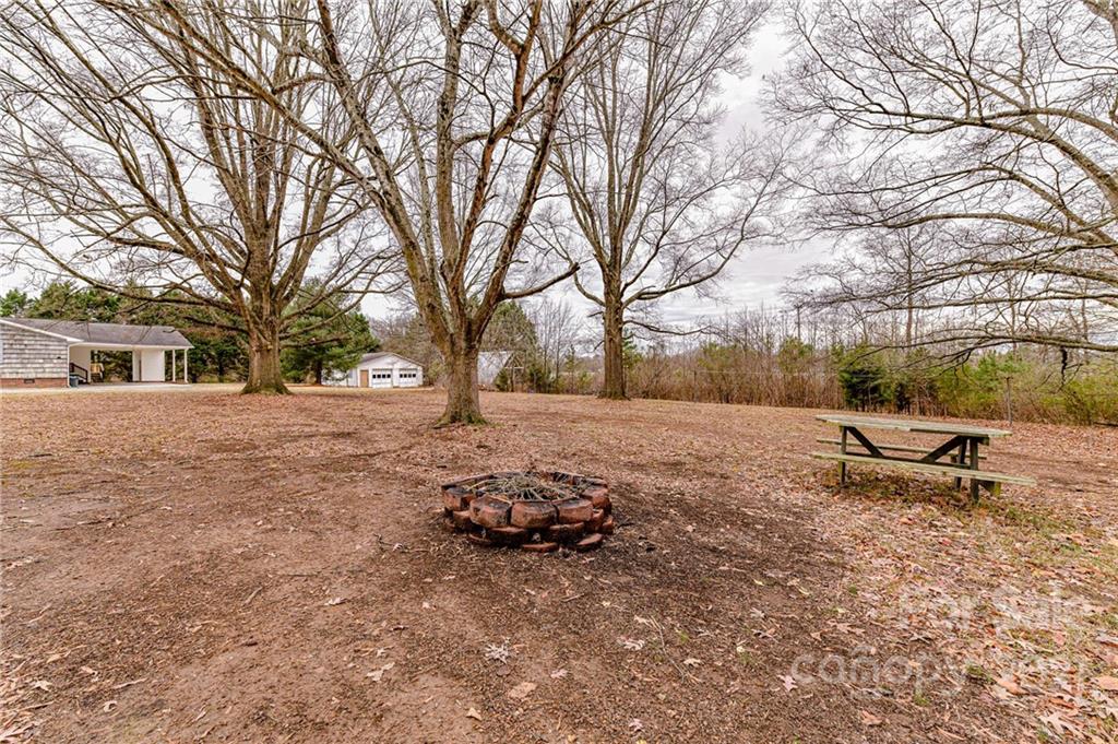 124 Baucom Deese Road Monroe, NC 28110 - Photo 22 of 26 a view of backyard with trees and outdoor space