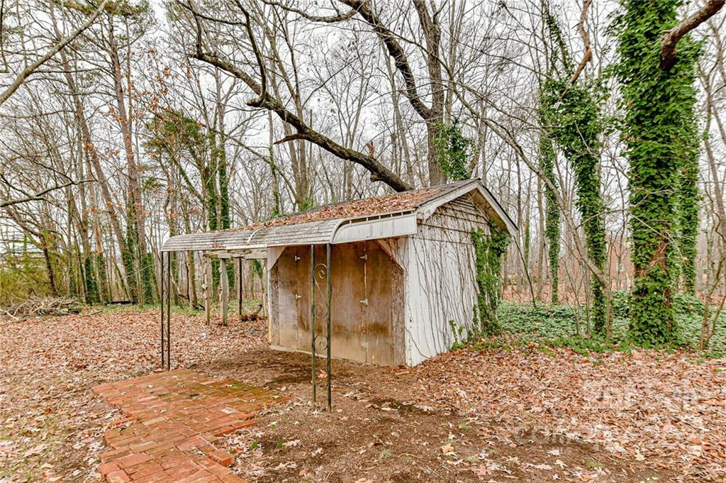 124 Baucom Deese Road Monroe, NC 28110 - Photo 25 of 26 a backyard of a house with large trees and wooden fence