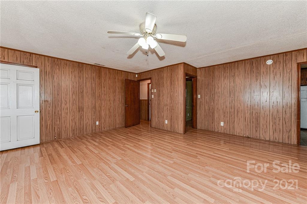124 Baucom Deese Road Monroe, NC 28110 - Photo 8 of 26 a view of an empty room with wooden floor