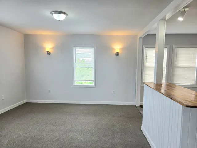 a kitchen with a stove top oven and white cabinet