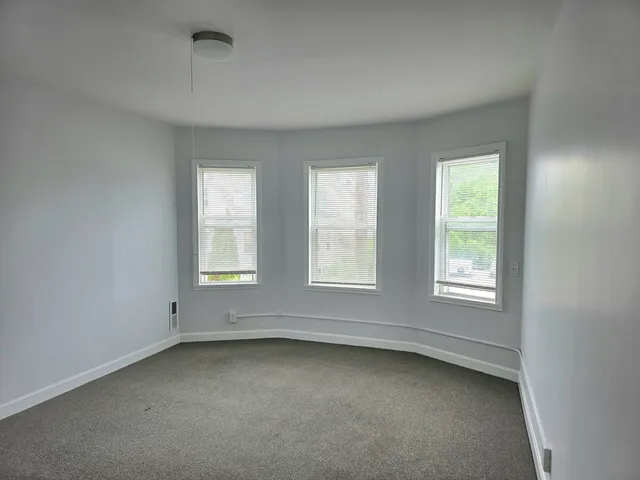 a kitchen with granite countertop white cabinets and stainless steel appliances