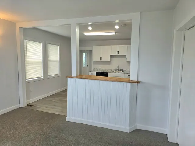 a kitchen with white cabinets and white appliances
