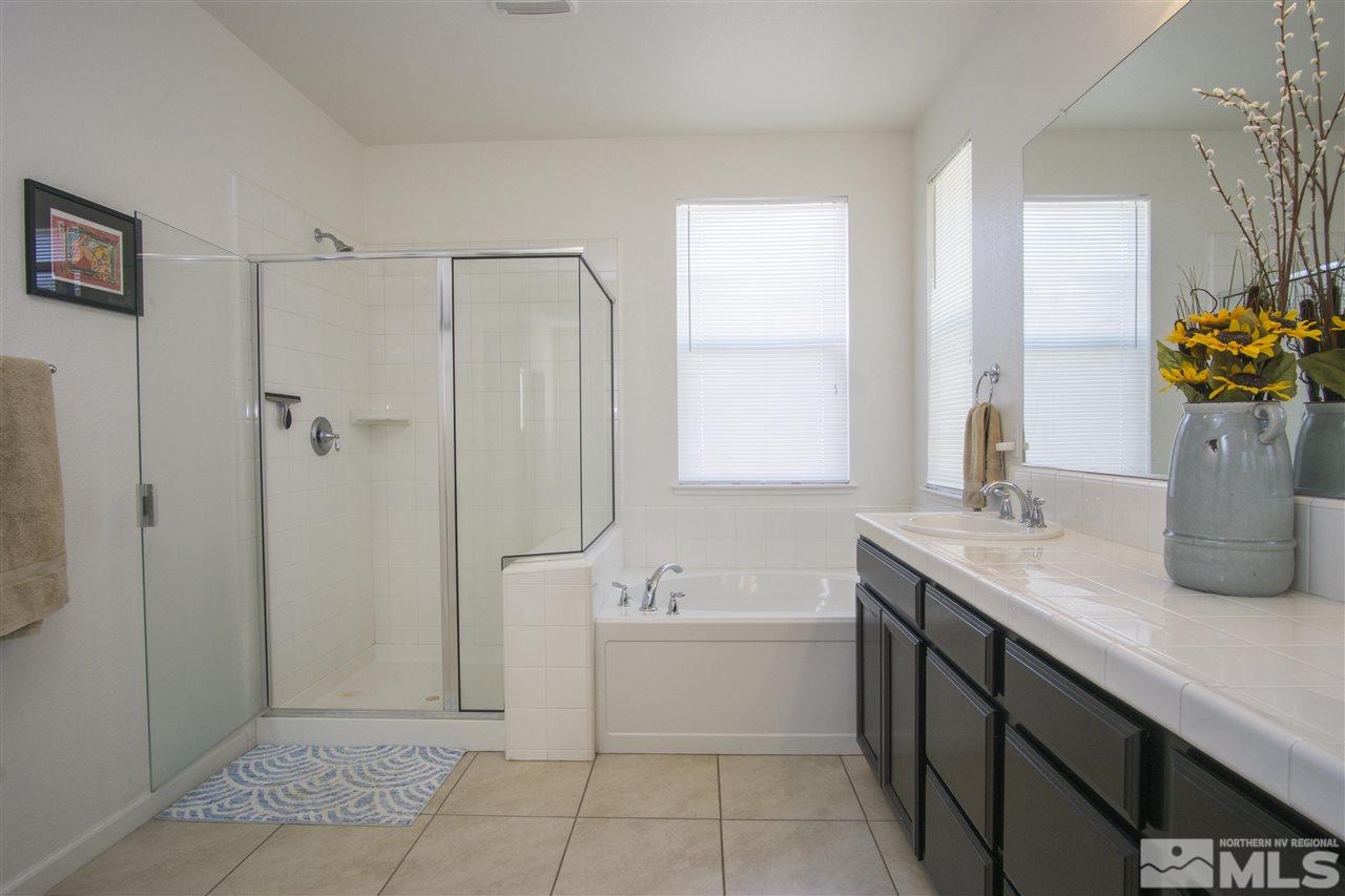 2090 Half Dome Drive Reno, NV 89521 - Photo 15 of 22 a bathroom with a tub sink and mirror