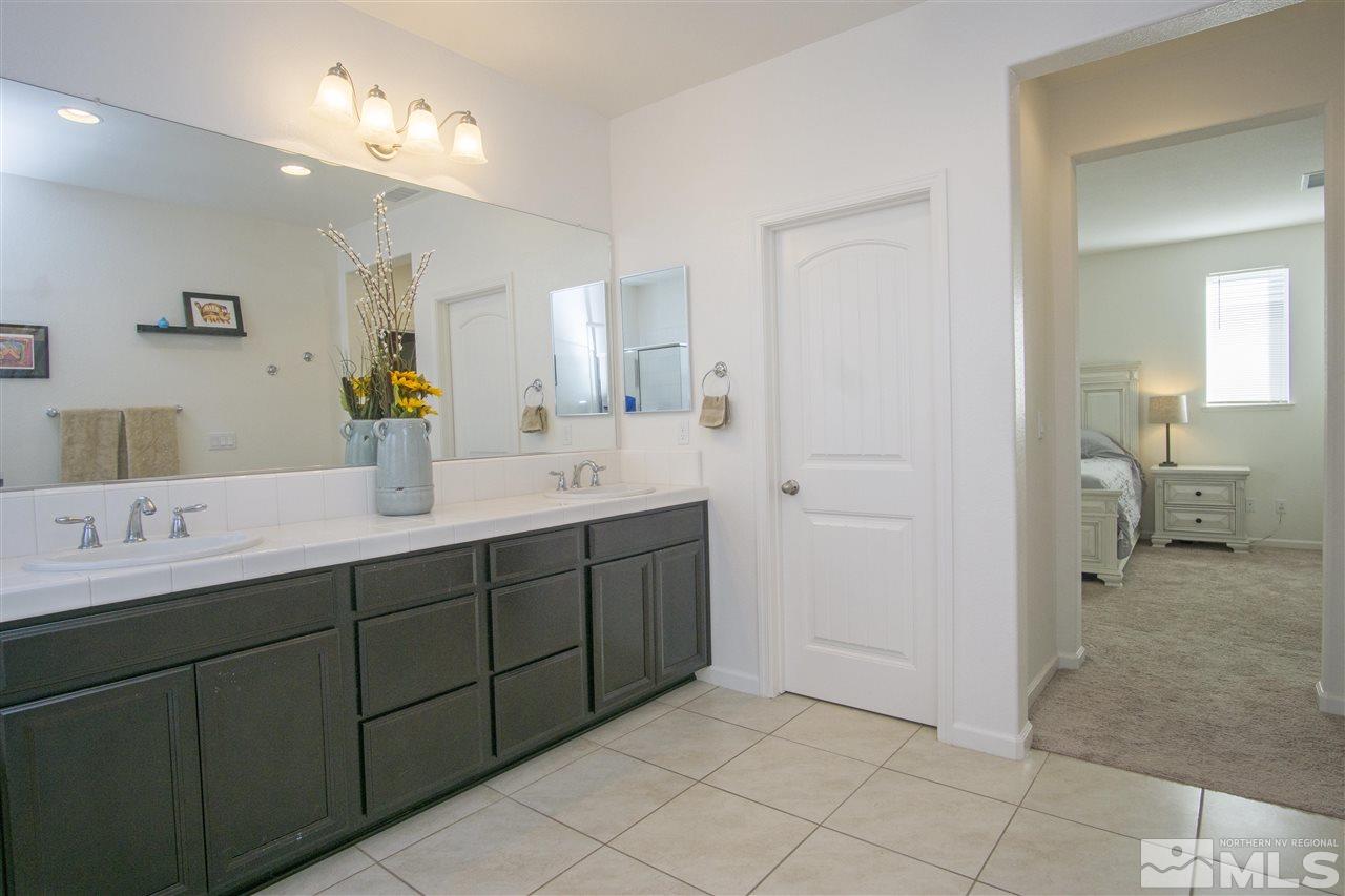 2090 Half Dome Drive Reno, NV 89521 - Photo 16 of 22 a spacious bathroom with a double vanity sink mirror and toilet