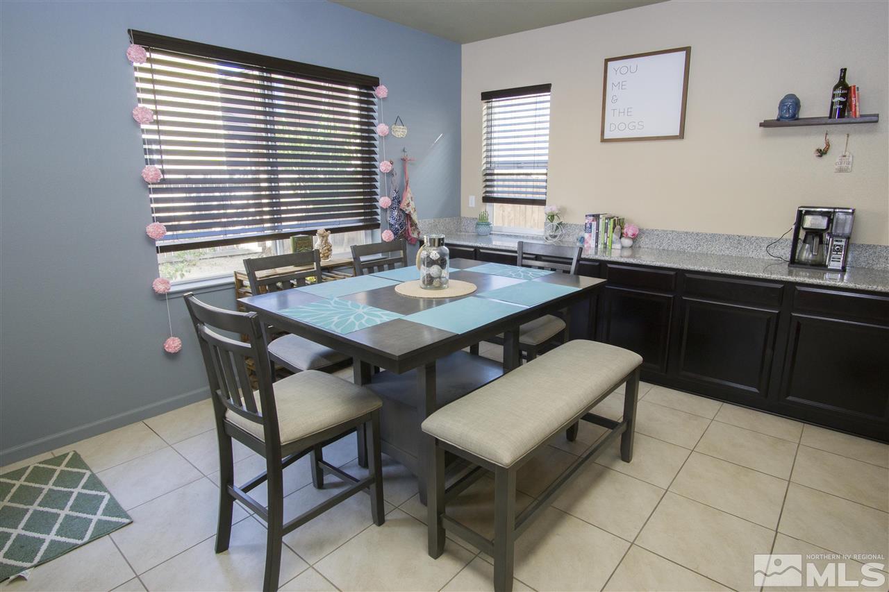 2090 Half Dome Drive Reno, NV 89521 - Photo 5 of 22 a dining room with a wooden table and chairs