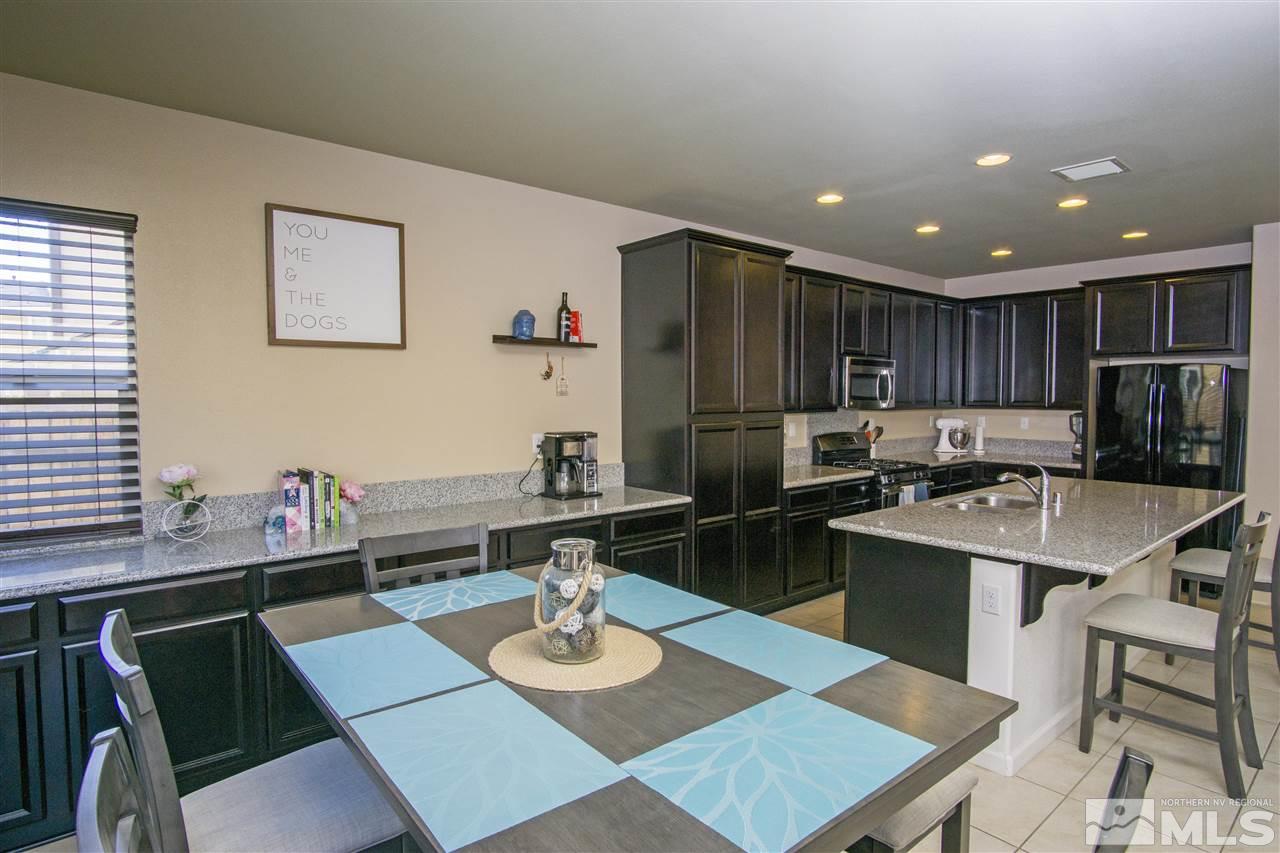 2090 Half Dome Drive Reno, NV 89521 - Photo 6 of 22 a kitchen with a dining table chairs and refrigerator