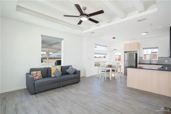a living room with furniture and a wooden floor