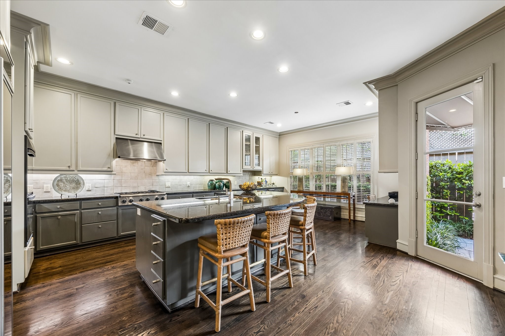 2627 Sutton Court Houston, TX 77027 - Photo 9 of 34 The kitchen is equipped with a large breakfast bar ideal for entertaining, a six-burner gas cooktop, a built-in refrigerator, and full-length cabinetry to the ceiling providing ample storage.