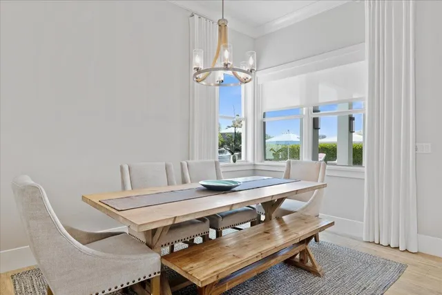 a kitchen with stainless steel appliances kitchen island granite countertop a refrigerator a stove a sink dishwasher and white cabinets with wooden floor