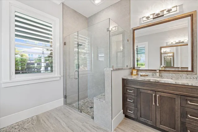 a white bath tub sitting in a bathroom next to a window