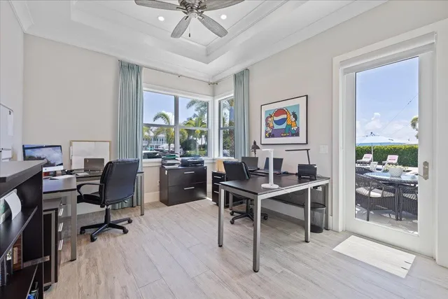a dining room with furniture a rug and a potted plant