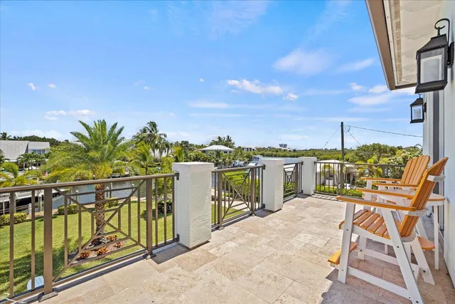 a view of a chairs and table on the deck in backyard