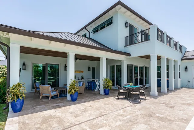 a view of a house with swimming pool and sitting area