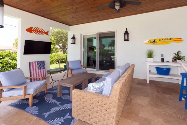 a view of a swimming pool with a table and chairs under an umbrella