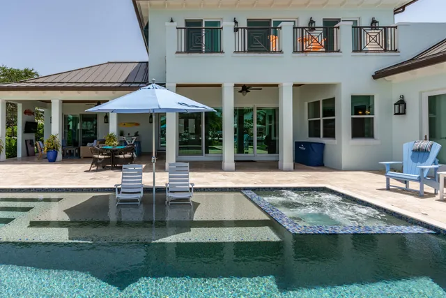 an aerial view of residential houses with outdoor space and river