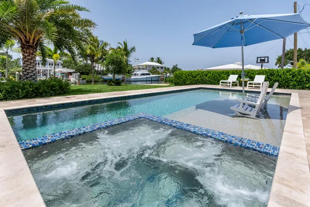 a aerial view of a house with a garden and lake view
