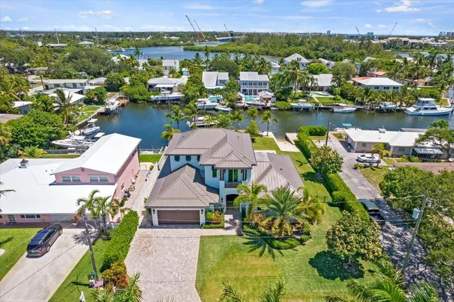 an aerial view of lake and residential houses with outdoor space