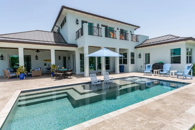 a view of a house with a yard and sitting area