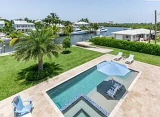 a large kitchen with kitchen island a large counter top appliances and cabinets