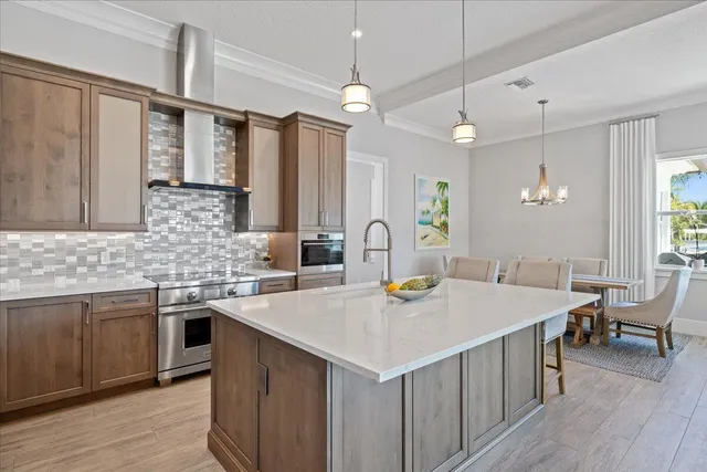 a kitchen with stainless steel appliances a stove a sink and a refrigerator