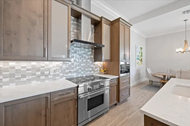 a large kitchen with kitchen island a sink table and chairs