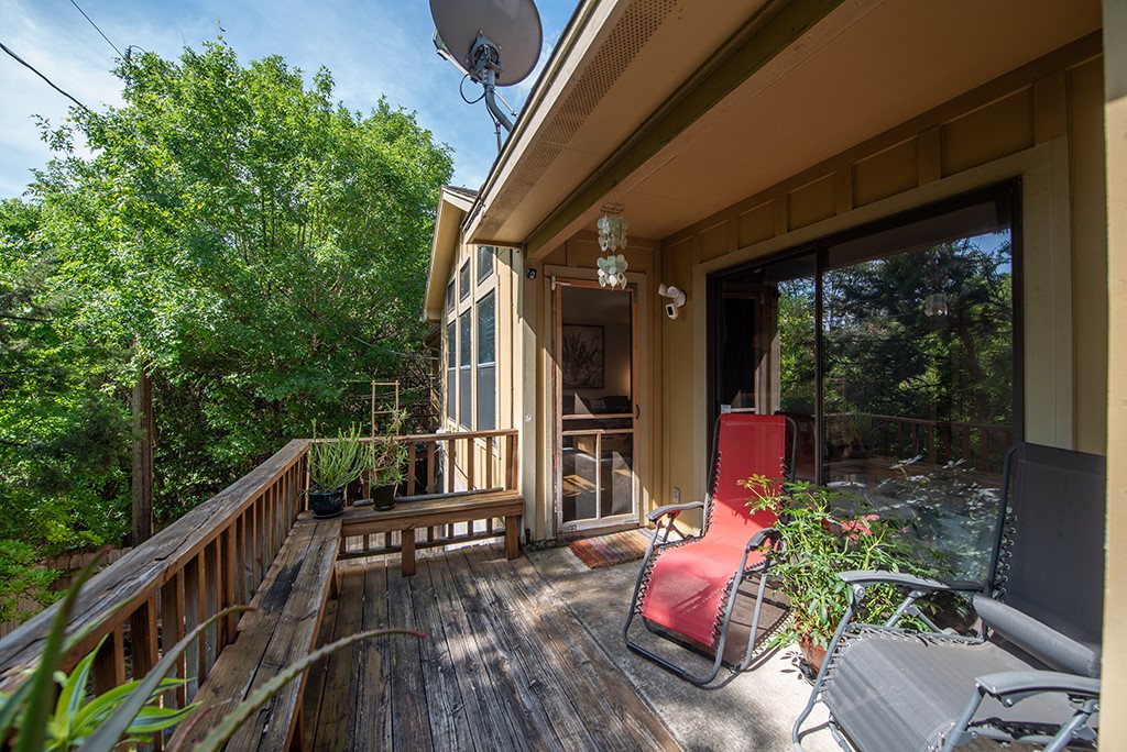 3609 Clawson Road, Unit A Austin, TX 78704 - Photo 13 of 17 A spacious wooden deck provides ample outdoor living space, surrounded by lush trees for natural privacy.