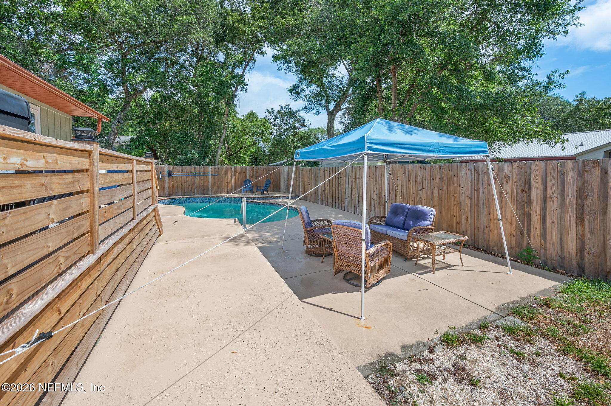 507 Gentian Road St. Augustine, FL 32086 - Photo 42 of 82 a view of backyard with a patio and a wooden bench