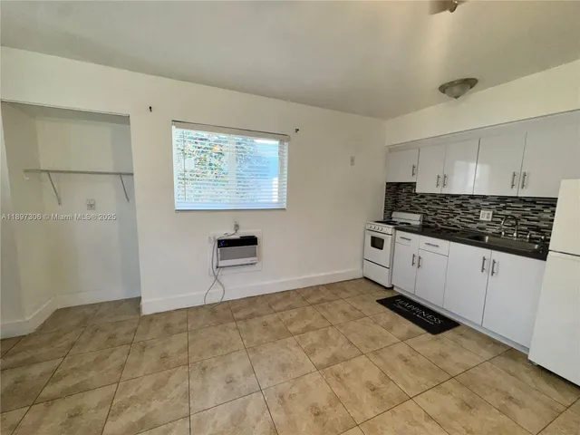 a kitchen with stainless steel appliances a stove a sink and a refrigerator