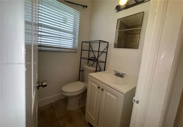 a bathroom with a sink toilet and mirror