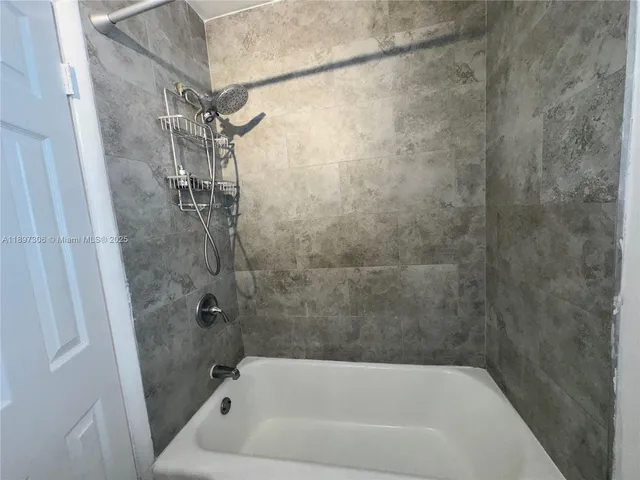 a bath tub sitting next to a shower