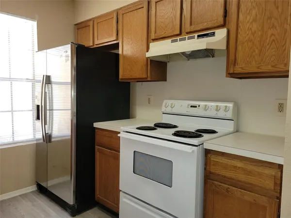 a kitchen with stainless steel appliances granite countertop a stove and a refrigerator