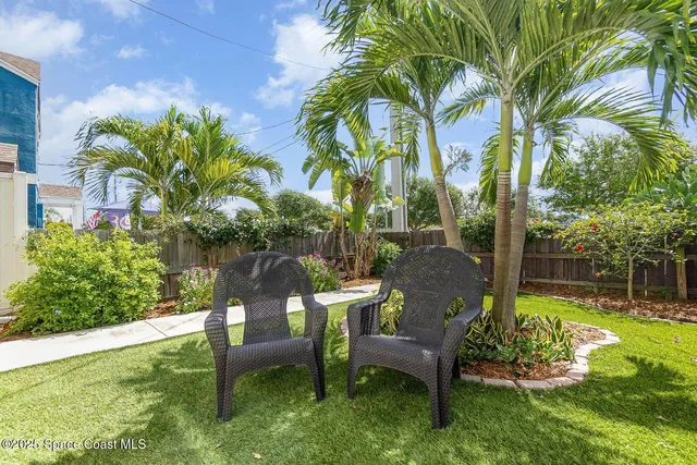 a view of a chair and table in backyard