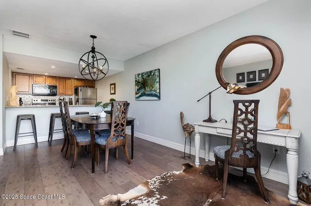 a dining room with furniture a rug and a chandelier