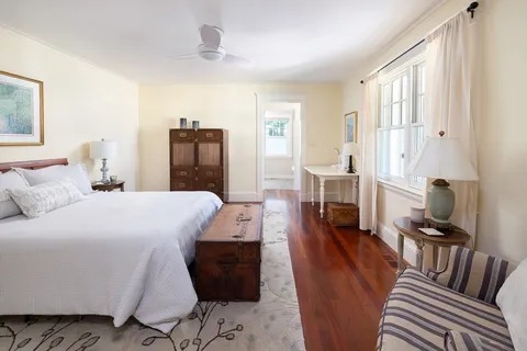 a bed room with a bed and wooden floor