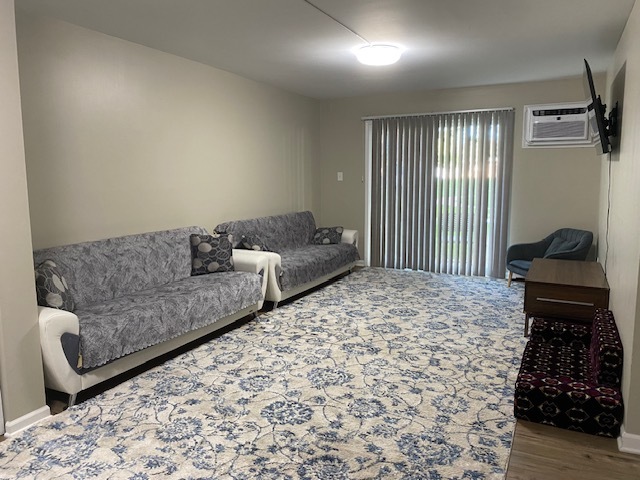 125 West Elk Trail, Unit 124 Carol Stream, IL 60188 - Photo 2 of 9 a living room with a couch and a window