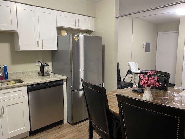 125 West Elk Trail, Unit 124 Carol Stream, IL 60188 - Photo 4 of 9 a kitchen with stainless steel appliances a sink cabinets and wooden floor