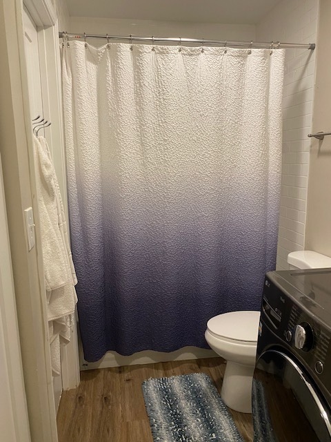 125 West Elk Trail, Unit 124 Carol Stream, IL 60188 - Photo 6 of 9 a bathroom with a toilet and a shower curtain