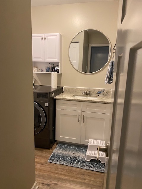 125 West Elk Trail, Unit 124 Carol Stream, IL 60188 - Photo 7 of 9 a utility room with a sink a washer and dryer