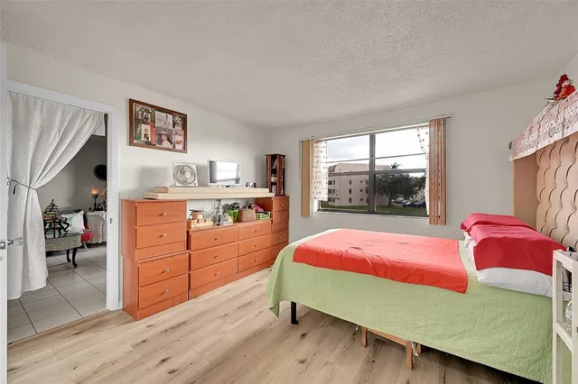 a view of a kitchen with dining room and wooden floor