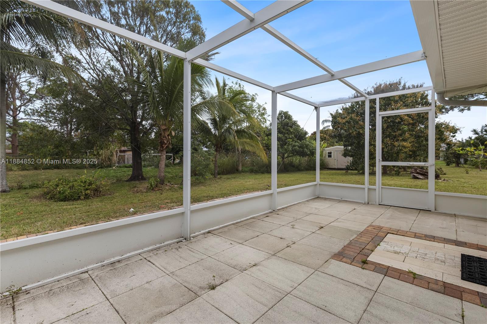 1517 Southeast Pitcher Road Port St. Lucie, FL 34952 - Photo 23 of 26 a view of a room with porch and a backyard