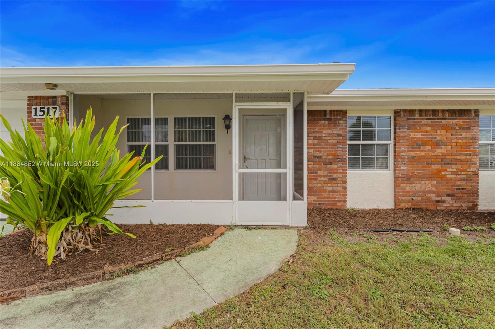 1517 Southeast Pitcher Road Port St. Lucie, FL 34952 - Photo 3 of 26 a front view of a house with a yard