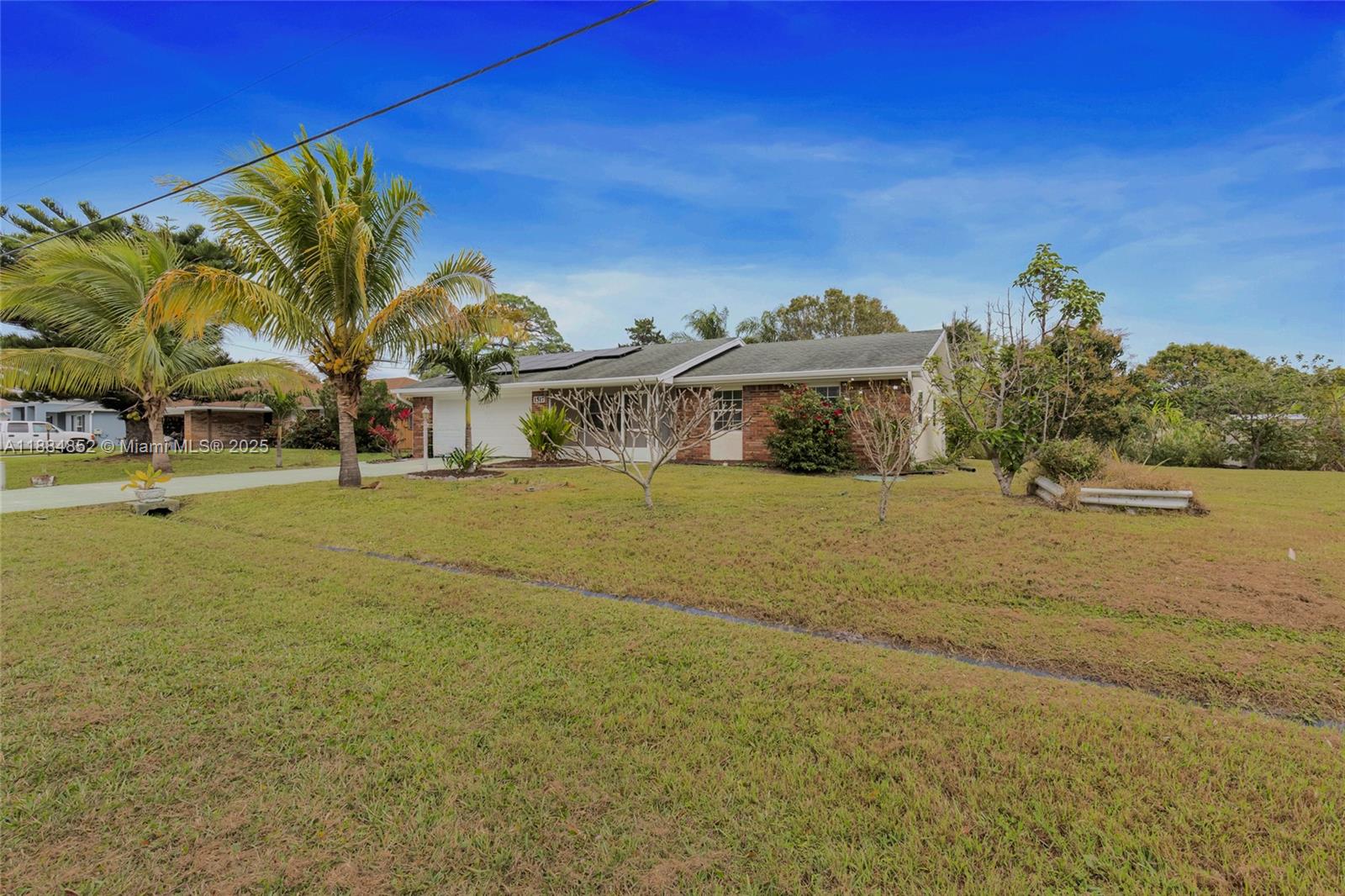 1517 Southeast Pitcher Road Port St. Lucie, FL 34952 - Photo 4 of 26 a view of a house with a yard
