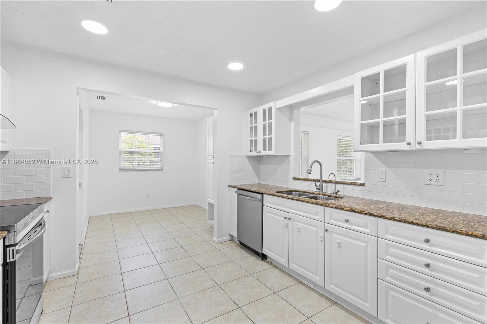 1517 Southeast Pitcher Road Port St. Lucie, FL 34952 - Photo 7 of 26 a kitchen with a sink and cabinets